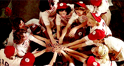Hands in center by female baseball team