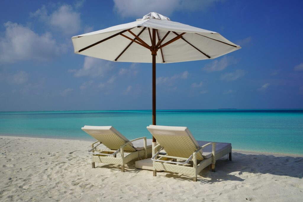 Two lounge chairs and umbrella at the beach