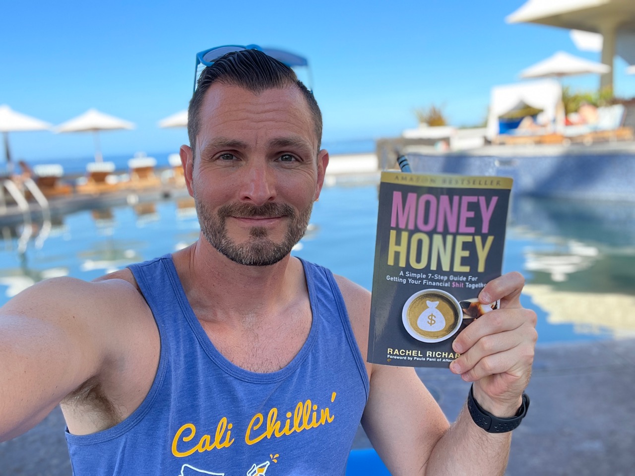 Reading the book Money Honey by the pool