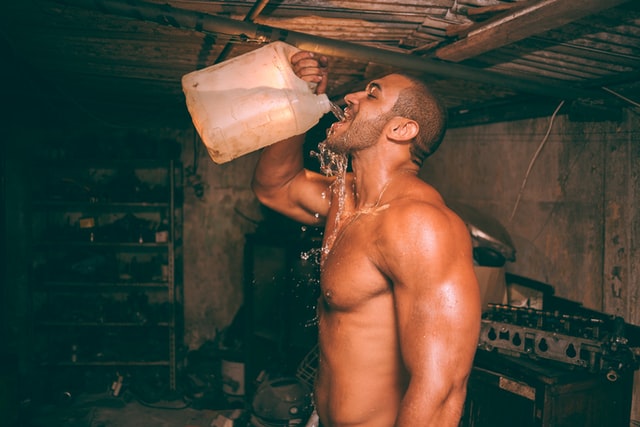 muscular man drinking water